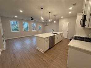 kitchen with dark wood-style floors, stainless steel appliances, a sink, and white cabinetry