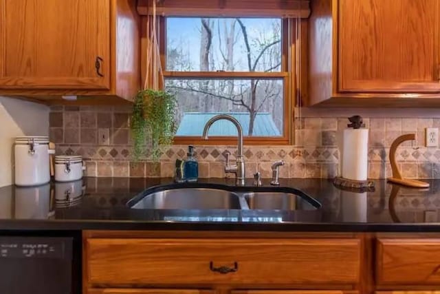 kitchen with dishwasher, tasteful backsplash, and sink