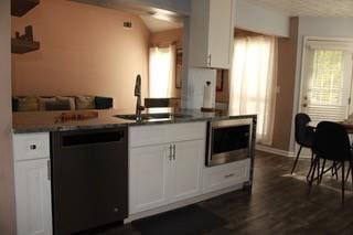 5022 Cliff Top Dr, Loganville, GA 30052 - kitchen featuring dark countertops, dishwasher, white cabinetry, and a sink