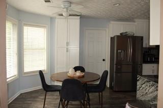 5022 Cliff Top Dr, Loganville, GA 30052 - dining room featuring dark wood-style floors, baseboards, a ceiling fan, and visible vents
