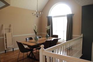 5022 Cliff Top Dr, Loganville, GA 30052 - dining room featuring vaulted ceiling, an inviting chandelier, and wood finished floors