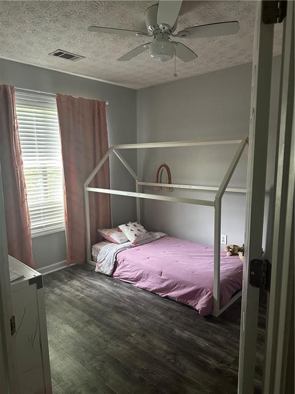 5022 Cliff Top Dr, Loganville, GA 30052 - bedroom with a textured ceiling, visible vents, and wood finished floors