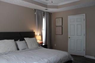 5022 Cliff Top Dr, Loganville, GA 30052 - bedroom featuring baseboards, a tray ceiling, and crown molding