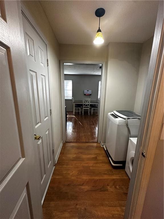 5022 Cliff Top Dr, Loganville, GA 30052 - hall featuring washing machine and clothes dryer, baseboards, and dark wood finished floors