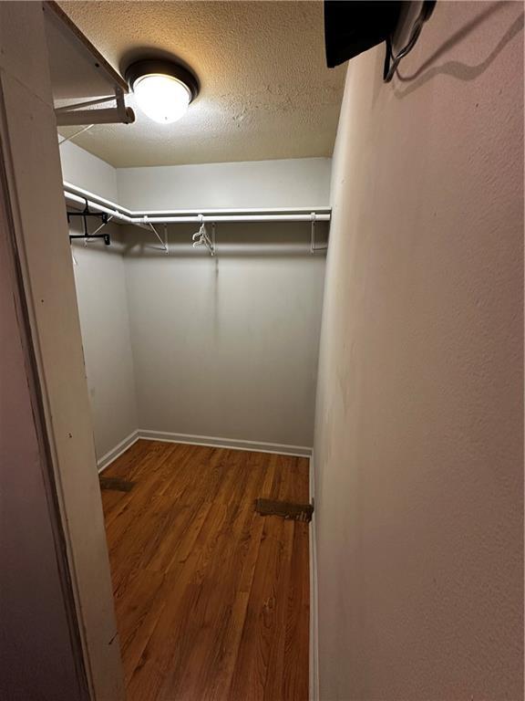 5022 Cliff Top Dr, Loganville, GA 30052 - walk in closet with wood finished floors
