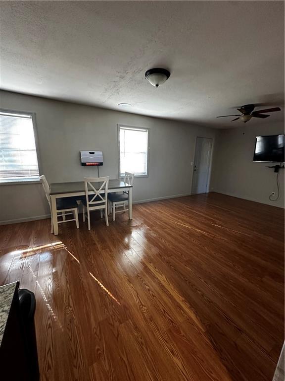 5022 Cliff Top Dr, Loganville, GA 30052 - dining area with a textured ceiling, wood finished floors, and a ceiling fan