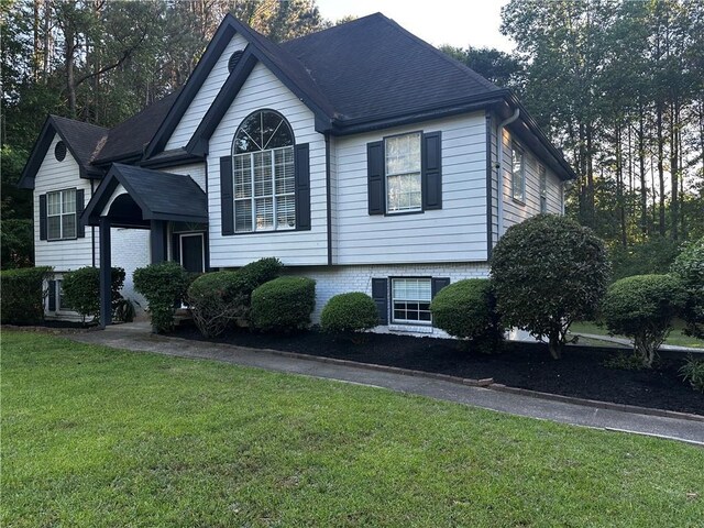 5022 Cliff Top Dr, Loganville, GA 30052 - view of property exterior featuring a lawn, roof with shingles, driveway, and a garage