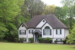 5022 Cliff Top Dr, Loganville, GA 30052 - view of home's exterior with a yard and a shingled roof