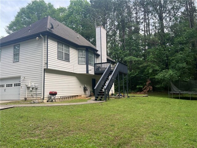 5022 Cliff Top Dr, Loganville, GA 30052 - view of yard featuring stairs, a trampoline, an outbuilding, and a storage unit