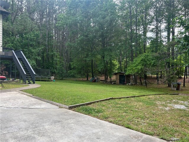 5022 Cliff Top Dr, Loganville, GA 30052 - view of yard with an outdoor structure and a storage unit