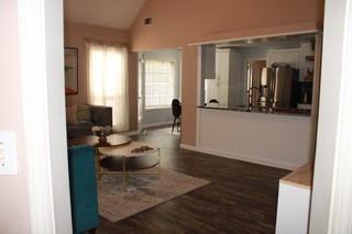 5022 Cliff Top Dr, Loganville, GA 30052 - living area with baseboards, wood finished floors, and vaulted ceiling