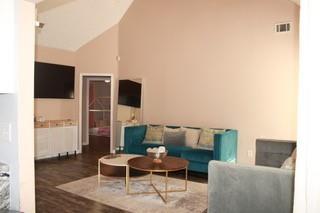 5022 Cliff Top Dr, Loganville, GA 30052 - living area with vaulted ceiling and wood finished floors