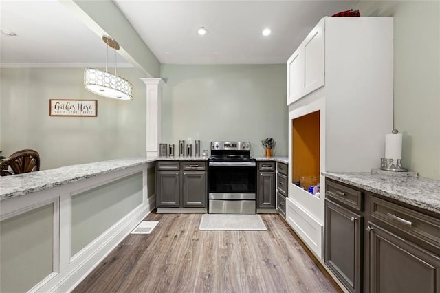 kitchen featuring crown molding, decorative light fixtures, light wood-type flooring, white cabinetry, and stainless steel electric range oven