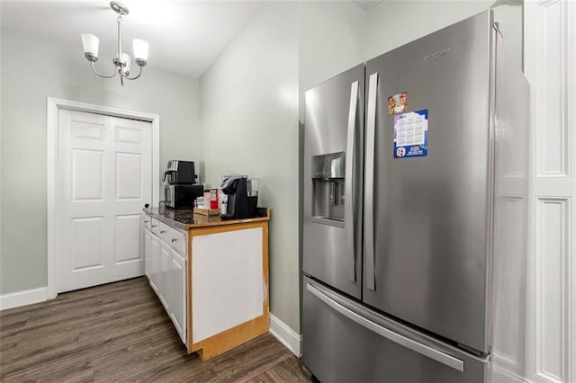 kitchen with white cabinetry, stainless steel fridge with ice dispenser, a chandelier, and dark hardwood / wood-style floors