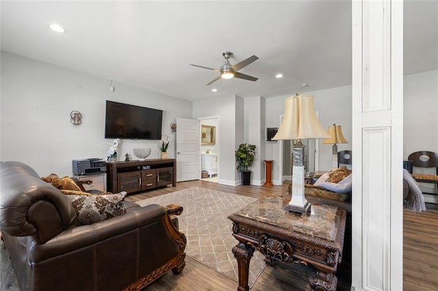 living room with hardwood / wood-style flooring and ceiling fan