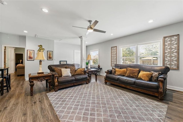 living room with hardwood / wood-style flooring, ornate columns, and ceiling fan