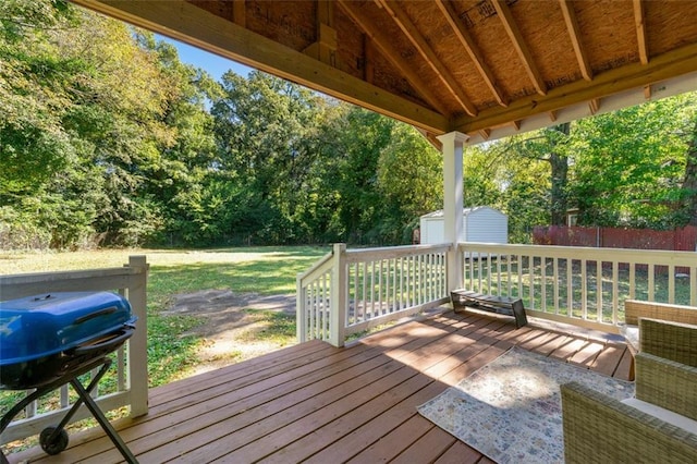 wooden deck with grilling area and a lawn