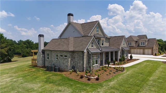 rear view of house featuring a yard and a garage