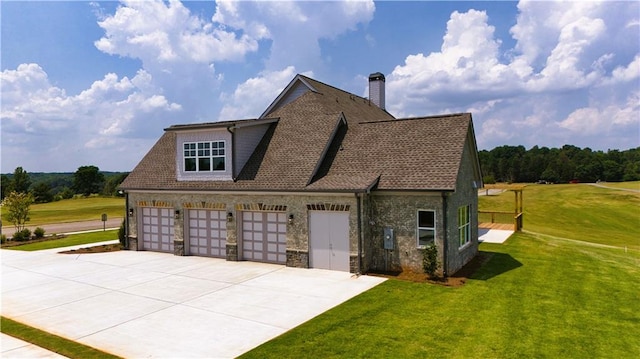 view of side of property with a garage and a lawn