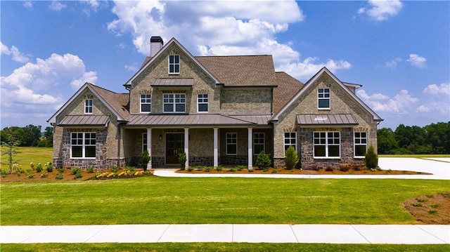 craftsman inspired home with a front lawn