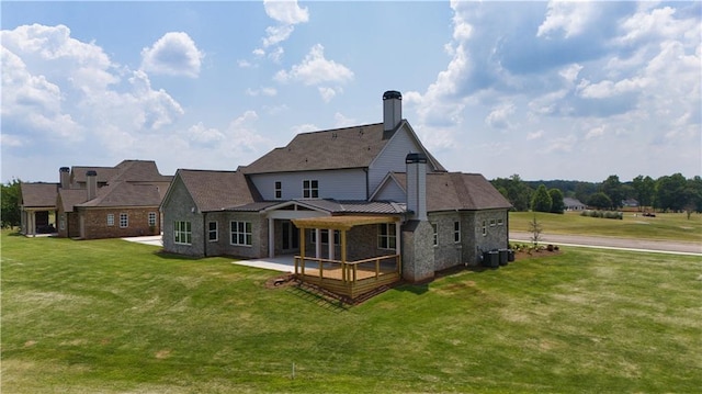 rear view of property with a lawn