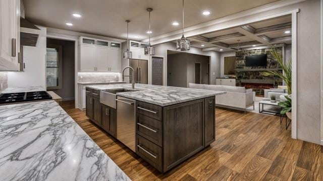 kitchen with dark brown cabinetry, coffered ceiling, white cabinetry, appliances with stainless steel finishes, and hardwood / wood-style flooring