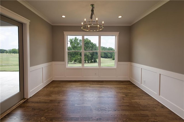 unfurnished dining area featuring a notable chandelier, dark wood-type flooring, and ornamental molding