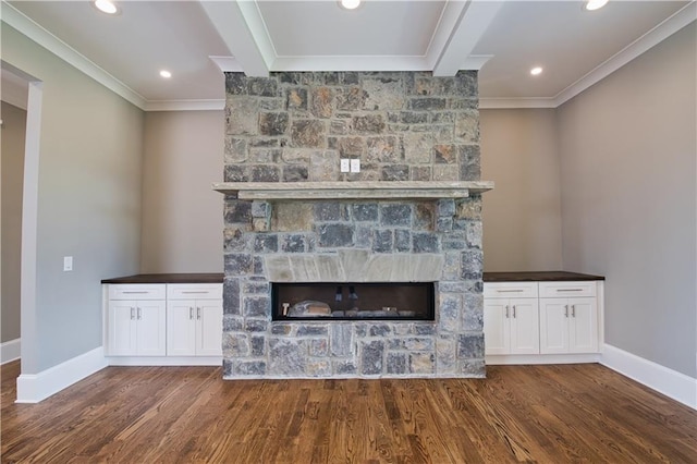 unfurnished living room with ornamental molding, dark hardwood / wood-style floors, and a stone fireplace