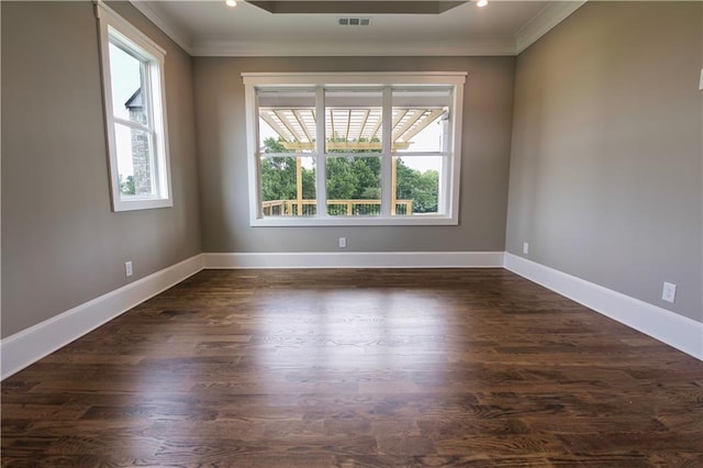 spare room featuring dark hardwood / wood-style flooring and crown molding