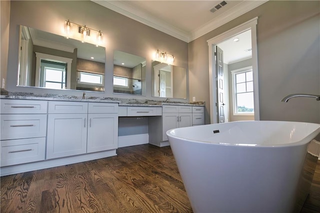 bathroom featuring a wealth of natural light, crown molding, and hardwood / wood-style floors