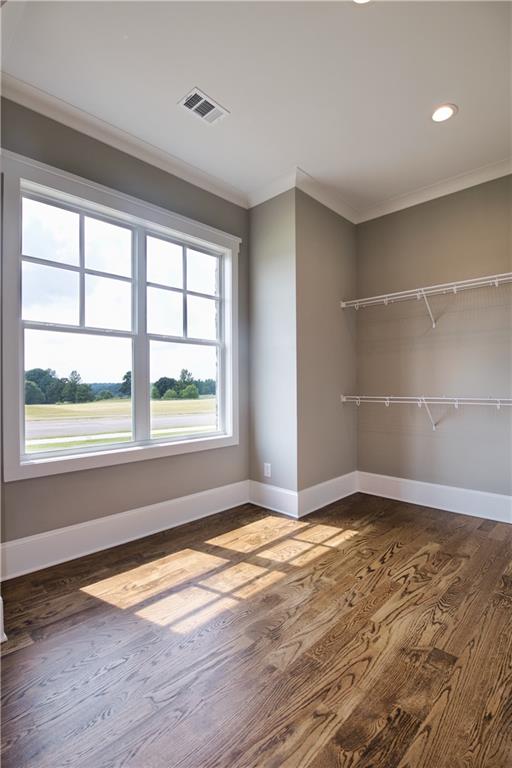 interior space with hardwood / wood-style flooring, a closet, and ornamental molding