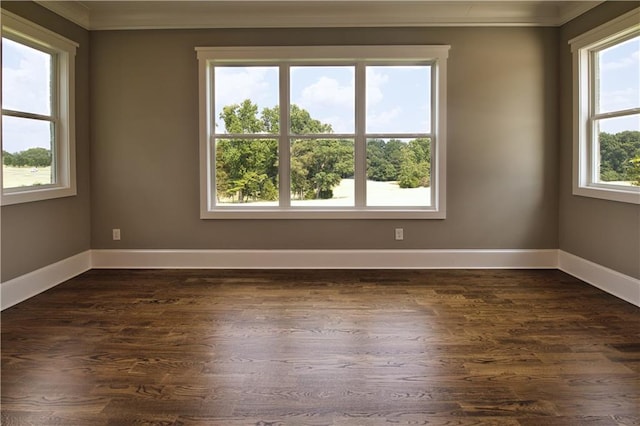 unfurnished room with dark hardwood / wood-style flooring, a healthy amount of sunlight, and ornamental molding