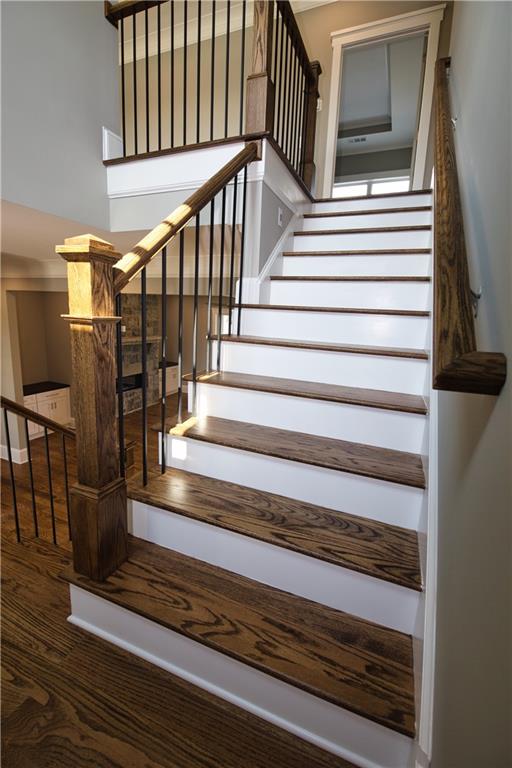 staircase with hardwood / wood-style floors