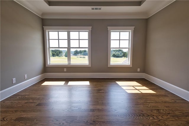 unfurnished room featuring dark wood-type flooring, ornamental molding, and a tray ceiling