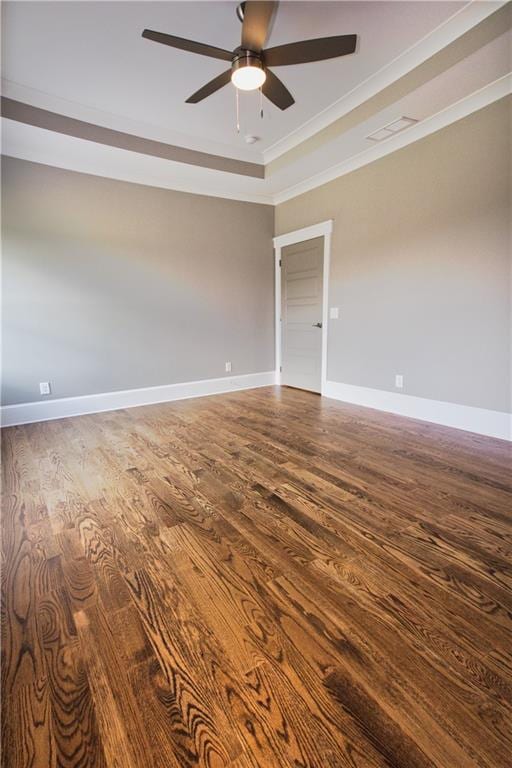 spare room featuring ceiling fan, wood-type flooring, and a tray ceiling