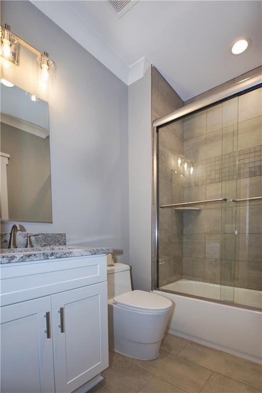 full bathroom featuring bath / shower combo with glass door, toilet, tile patterned floors, and vanity