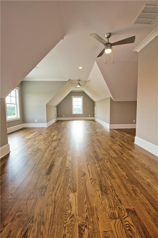 bonus room featuring ceiling fan, vaulted ceiling, and hardwood / wood-style floors