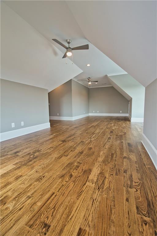 bonus room featuring ceiling fan, hardwood / wood-style floors, and lofted ceiling