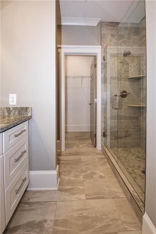 bathroom with tile patterned flooring, vanity, and a shower with shower door