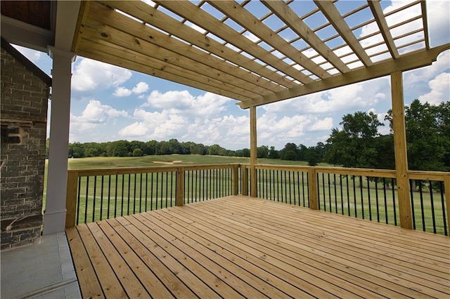 deck with a pergola and a yard