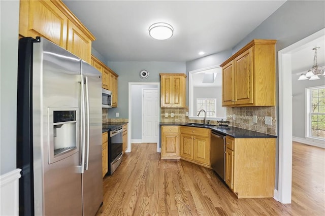 336 Toto Dr, Dawsonville, GA 30534 - kitchen with light wood-type flooring, stainless steel appliances, backsplash, and a sink