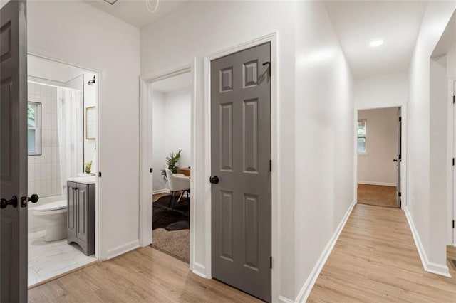 hall with light wood-type flooring