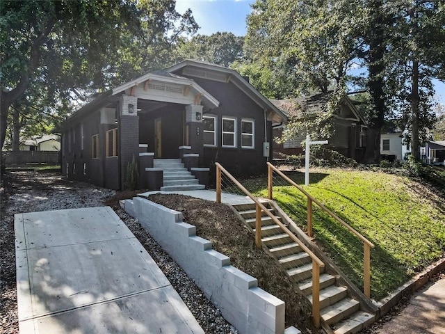 bungalow-style home featuring a front lawn