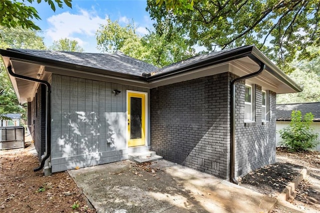 entrance to property with a patio and central AC