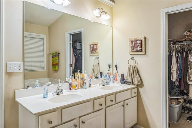 2606 Fairmont Park Ct, Dacula, GA 30019 - bathroom with double vanity, a spacious closet, and a sink