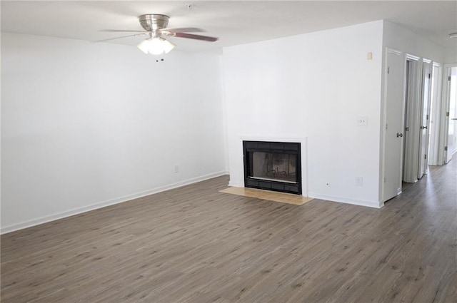 unfurnished living room featuring wood-type flooring and ceiling fan