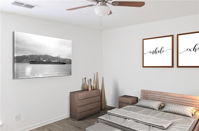 bedroom with ceiling fan and hardwood / wood-style flooring