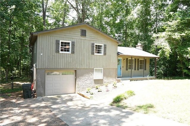 split level home featuring covered porch and a garage