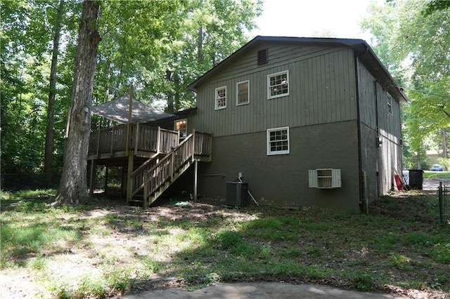 back of house with central AC and a deck