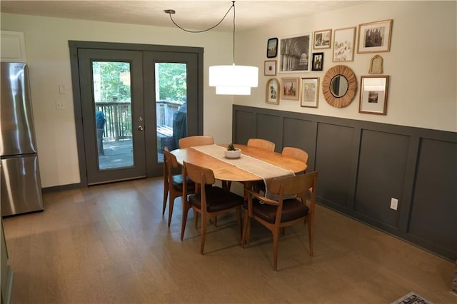 dining room featuring wood-type flooring and french doors